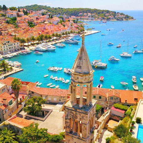 Elevated view looking down over the rooftops and marina in Hvar