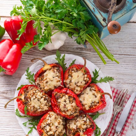 Stuffed red peppers on a white plate