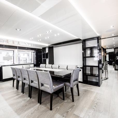 Dining area onboard charter yacht SONISHI, 12-seater table with windows adjacent.