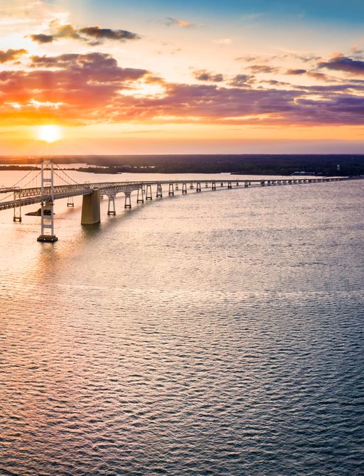 Aerial panorama of Chesapeake Bay Bridge at sunset.